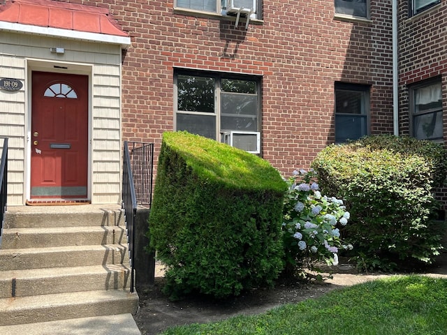 191-09 39th Ave Unit 164, Flushing, NY 11358 - view of exterior entry featuring brick siding and a standing seam roof