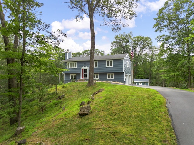16 Mountain View Dr, Holmes, NY 12531 - bi-level home with a chimney, driveway, a garage, and a front lawn