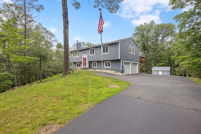 16 Mountain View Dr, Holmes, NY 12531 - split foyer home featuring a chimney, an attached garage, asphalt driveway, and a front lawn