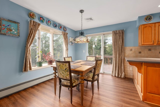 16 Mountain View Dr, Holmes, NY 12531 - dining area featuring a baseboard heating unit, plenty of natural light, a chandelier, and light wood-type flooring