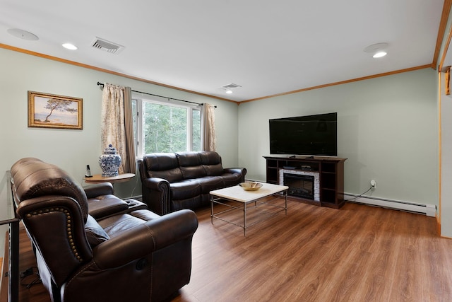 16 Mountain View Dr, Holmes, NY 12531 - living area featuring baseboard heating, ornamental molding, wood finished floors, a tiled fireplace, and recessed lighting