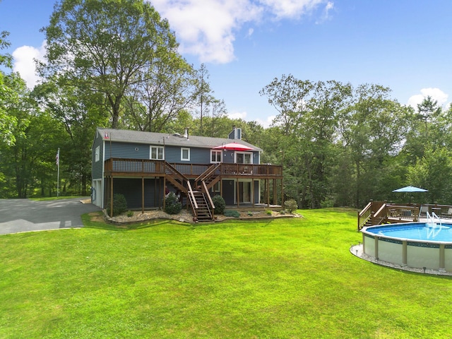 16 Mountain View Dr, Holmes, NY 12531 - rear view of property featuring stairs, a wooden deck, a lawn, and an outdoor pool