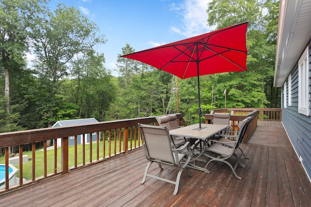 16 Mountain View Dr, Holmes, NY 12531 - wooden terrace with outdoor dining area, a yard, and a wooded view