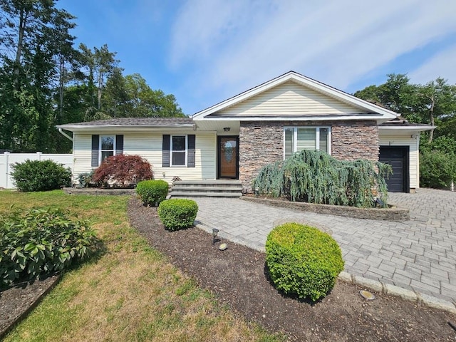 143 N Summit Ave, Patchogue, NY 11772 - ranch-style home featuring a garage, stone siding, and decorative driveway