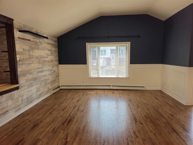 143 N Summit Ave, Patchogue, NY 11772 - empty room featuring hardwood / wood-style floors, baseboard heating, a wainscoted wall, and lofted ceiling