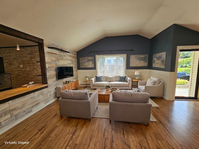 143 N Summit Ave, Patchogue, NY 11772 - living room with wood finished floors, vaulted ceiling, and wainscoting