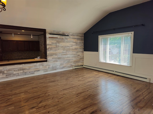 143 N Summit Ave, Patchogue, NY 11772 - unfurnished living room featuring a baseboard radiator, a wainscoted wall, vaulted ceiling, and wood finished floors