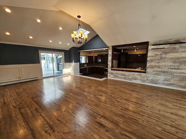 143 N Summit Ave, Patchogue, NY 11772 - unfurnished living room with baseboard heating, hardwood / wood-style floors, a decorative wall, a chandelier, and wainscoting