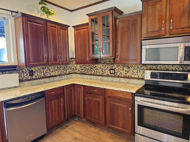 143 N Summit Ave, Patchogue, NY 11772 - kitchen with stainless steel appliances, decorative backsplash, light wood-style flooring, glass insert cabinets, and light stone counters