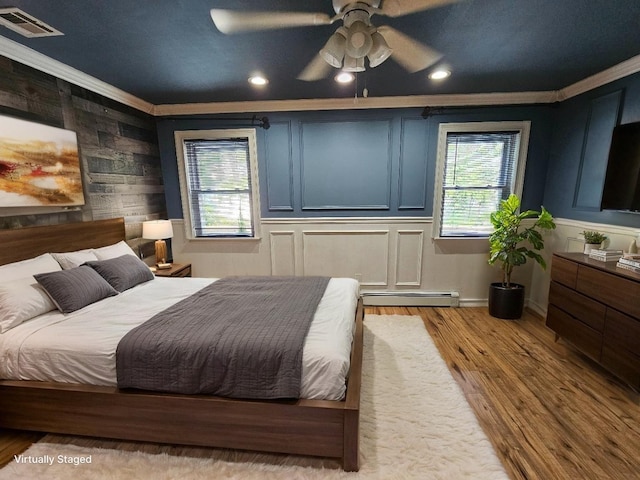 143 N Summit Ave, Patchogue, NY 11772 - bedroom with a baseboard radiator, ornamental molding, wood finished floors, recessed lighting, and a ceiling fan