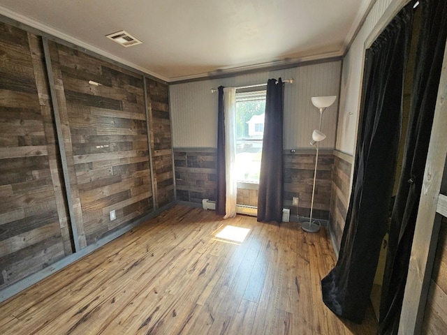 143 N Summit Ave, Patchogue, NY 11772 - empty room with ornamental molding, wood walls, hardwood / wood-style floors, and wainscoting