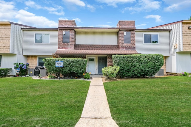 80 Pointe Cir S Unit 80, Coram, NY 11727 - view of property featuring a chimney and a front yard