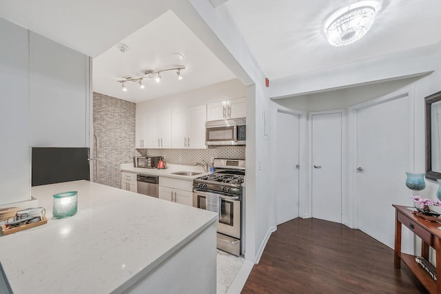 80 Pointe Cir S Unit 80, Coram, NY 11727 - kitchen with appliances with stainless steel finishes, white cabinetry, wood finished floors, and tasteful backsplash