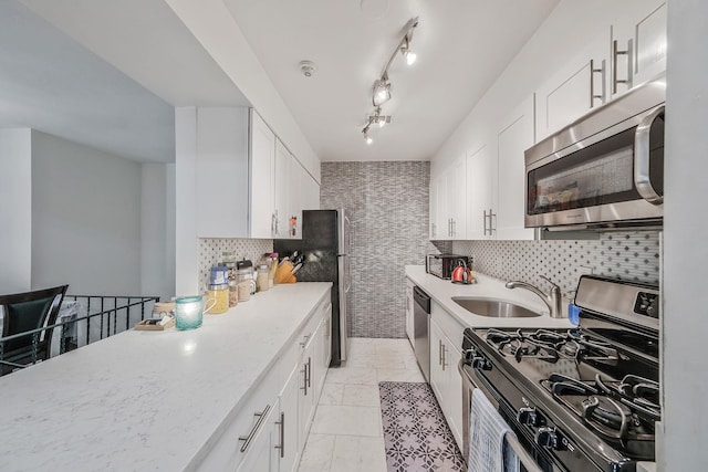 80 Pointe Cir S Unit 80, Coram, NY 11727 - kitchen featuring stainless steel appliances, white cabinetry, tasteful backsplash, light stone counters, and light tile patterned floors