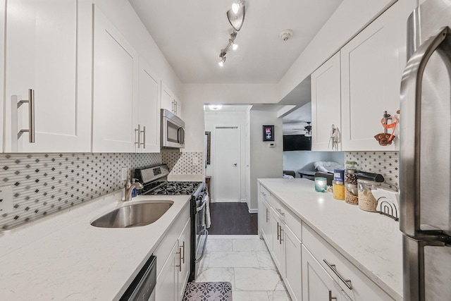 80 Pointe Cir S Unit 80, Coram, NY 11727 - kitchen featuring appliances with stainless steel finishes, white cabinets, light marble finish floors, tasteful backsplash, and light stone counters