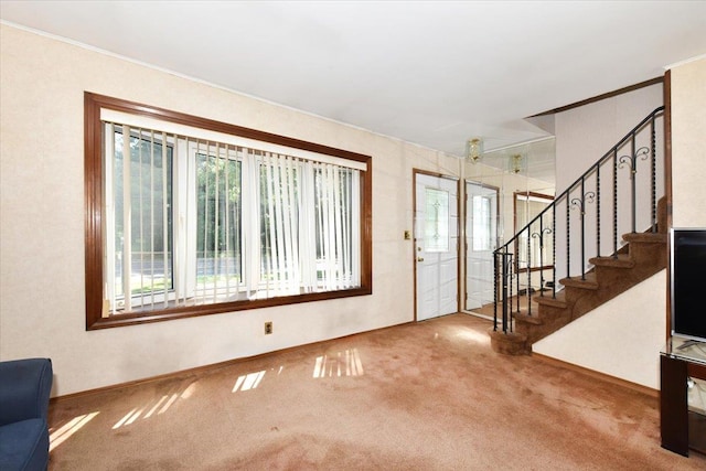 42 N Coleman Rd, Centereach, NY 11720 - entrance foyer with carpet flooring, stairway, and crown molding