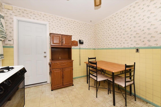 42 N Coleman Rd, Centereach, NY 11720 - dining room featuring wallpapered walls, tile walls, wainscoting, and light flooring