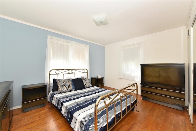 42 N Coleman Rd, Centereach, NY 11720 - bedroom with crown molding and wood-type flooring