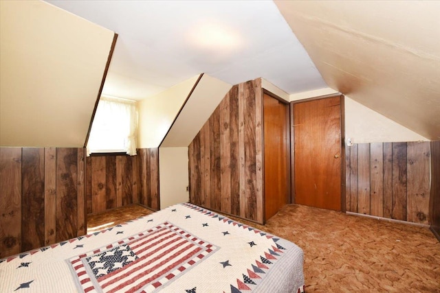 42 N Coleman Rd, Centereach, NY 11720 - bedroom with wood walls, lofted ceiling, and carpet floors