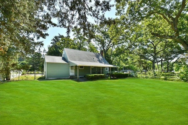 42 N Coleman Rd, Centereach, NY 11720 - rear view of house with view of scattered trees