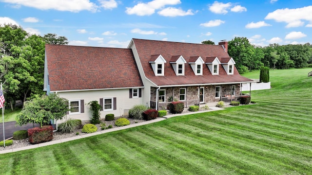 331 Ridge Rd, Campbell Hall, NY 10916 - new england style home featuring a porch, a chimney, a front yard, and stone siding