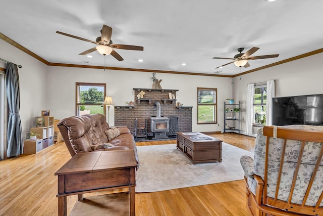 331 Ridge Rd, Campbell Hall, NY 10916 - living room featuring a ceiling fan, a wood stove, light wood-style flooring, recessed lighting, and crown molding