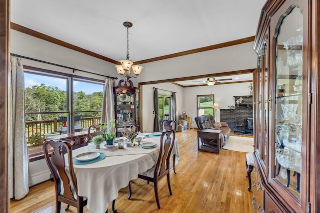 331 Ridge Rd, Campbell Hall, NY 10916 - dining space featuring crown molding, light wood-style flooring, a fireplace, and ceiling fan