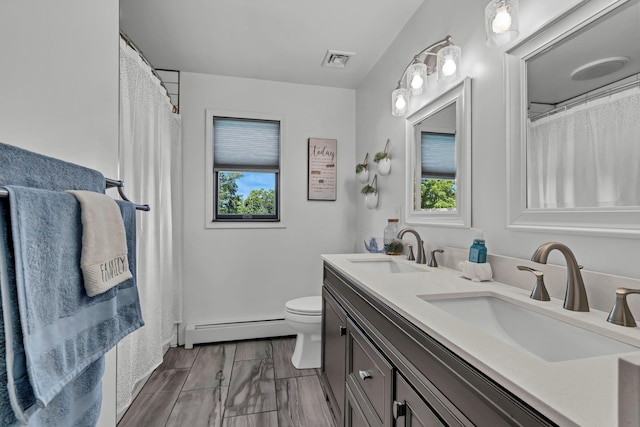 331 Ridge Rd, Campbell Hall, NY 10916 - bathroom featuring baseboard heating, double vanity, and plenty of natural light