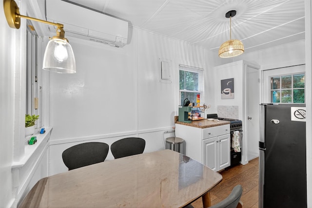 11 Apache Ln, Ferndale, NY 12734 - dining room featuring an AC wall unit, dark wood-type flooring, and healthy amount of natural light