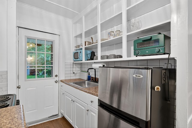 11 Apache Ln, Ferndale, NY 12734 - kitchen with freestanding refrigerator, white cabinetry, backsplash, and dark wood-style floors