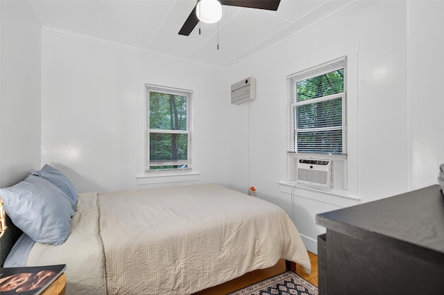 11 Apache Ln, Ferndale, NY 12734 - bedroom with a wall unit AC, multiple windows, crown molding, cooling unit, and wood finished floors