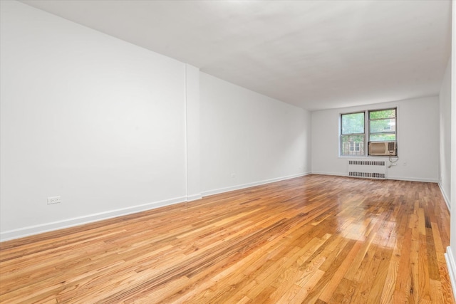 67-30 Clyde St Unit 3L, Forest Hills, NY 11375 - spare room with radiator and light wood-type flooring