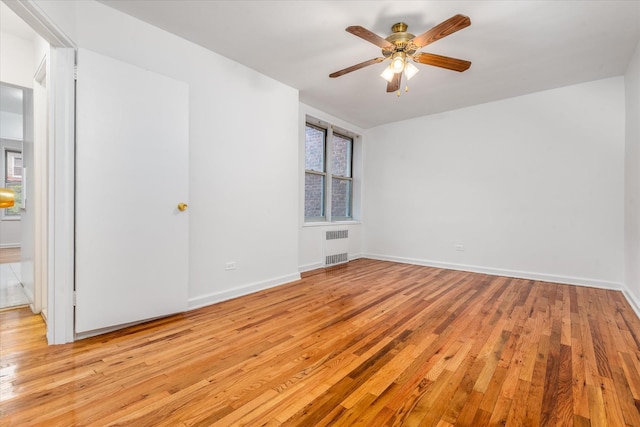 67-30 Clyde St Unit 3L, Forest Hills, NY 11375 - spare room featuring light wood-type flooring, a ceiling fan, and radiator