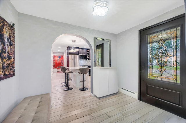 45 Potter Ln, Levittown, NY 11756 - entryway featuring baseboard heating, arched walkways, and light wood-style floors