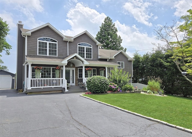 8 Mannes St, Ronkonkoma, NY 11779 - view of front of property featuring covered porch, a chimney, an outbuilding, a front lawn, and asphalt driveway