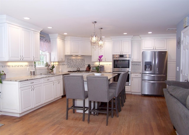 8 Mannes St, Ronkonkoma, NY 11779 - kitchen with stainless steel appliances, white cabinets, and recessed lighting