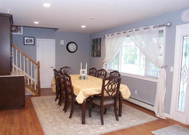 8 Mannes St, Ronkonkoma, NY 11779 - dining area featuring baseboard heating, stairs, wood finished floors, and recessed lighting