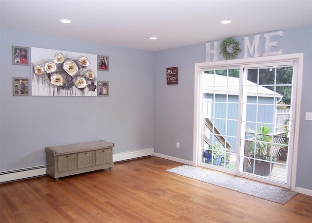 8 Mannes St, Ronkonkoma, NY 11779 - spare room with wood finished floors, a baseboard heating unit, and recessed lighting