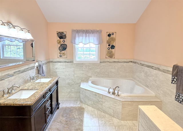 8 Mannes St, Ronkonkoma, NY 11779 - bathroom featuring a garden tub, double vanity, tile walls, wainscoting, and tile patterned floors