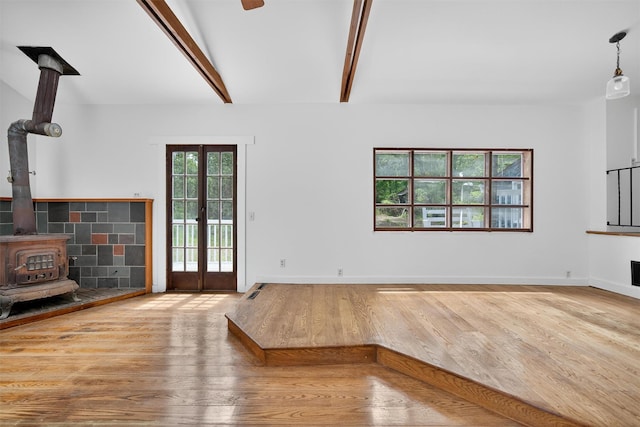 123 Newport Bridge Rd, Warwick, NY 10990 - unfurnished living room with wood finished floors, a wood stove, beam ceiling, and french doors