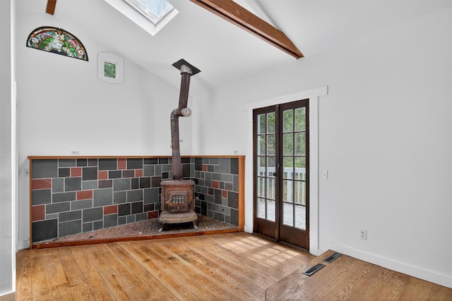 123 Newport Bridge Rd, Warwick, NY 10990 - detailed view of a skylight, a wood stove, wood finished floors, beamed ceiling, and french doors
