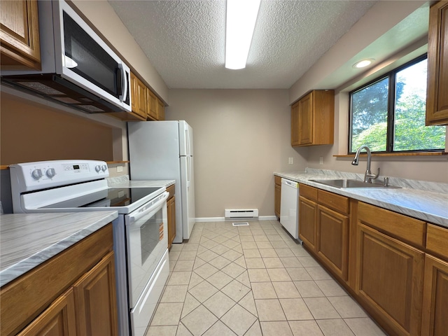 59 Meadowlark Ln, Woodridge, NY 12789 - kitchen with white appliances, a textured ceiling, light countertops, a baseboard heating unit, and brown cabinets