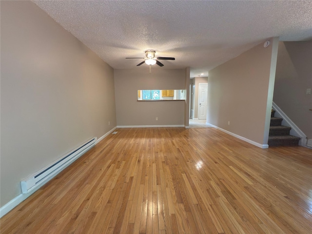 59 Meadowlark Ln, Woodridge, NY 12789 - unfurnished room with a baseboard heating unit, a textured ceiling, light wood-style floors, stairs, and a ceiling fan