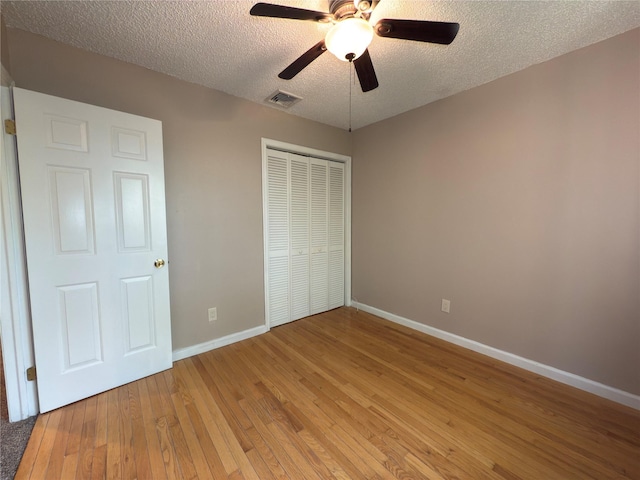 59 Meadowlark Ln, Woodridge, NY 12789 - unfurnished bedroom with light wood finished floors, a closet, a textured ceiling, and a ceiling fan