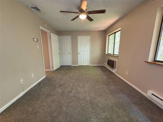 59 Meadowlark Ln, Woodridge, NY 12789 - unfurnished bedroom with a textured ceiling, baseboard heating, dark colored carpet, ceiling fan, and a wall unit AC
