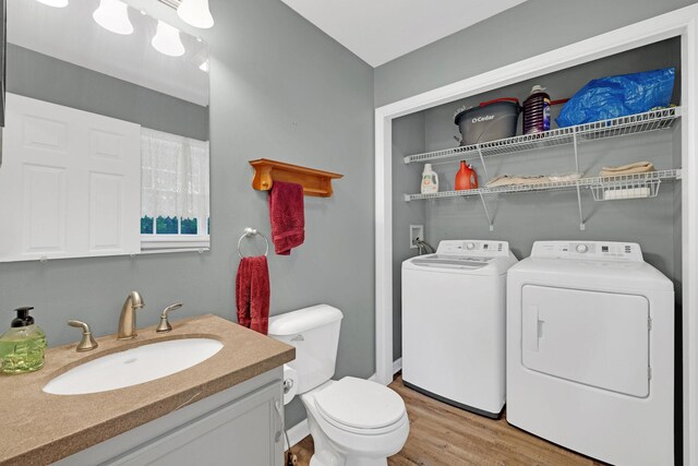 27 Balsam Rd, Hyde Park, NY 12538 - bathroom featuring washer and dryer, wood finished floors, and vanity