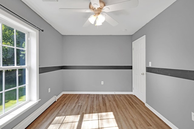 27 Balsam Rd, Hyde Park, NY 12538 - empty room with a baseboard radiator, healthy amount of natural light, and wood finished floors