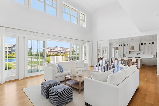 1 Fiske Ave, Westhampton Beach, NY 11978 - living room featuring a high ceiling and light wood finished floors