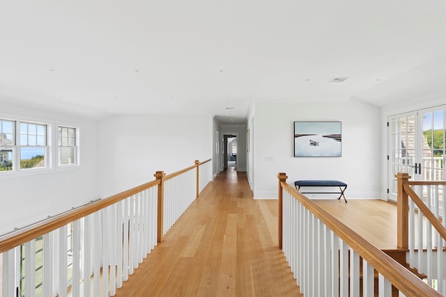 1 Fiske Ave, Westhampton Beach, NY 11978 - corridor with light wood-style floors and an upstairs landing