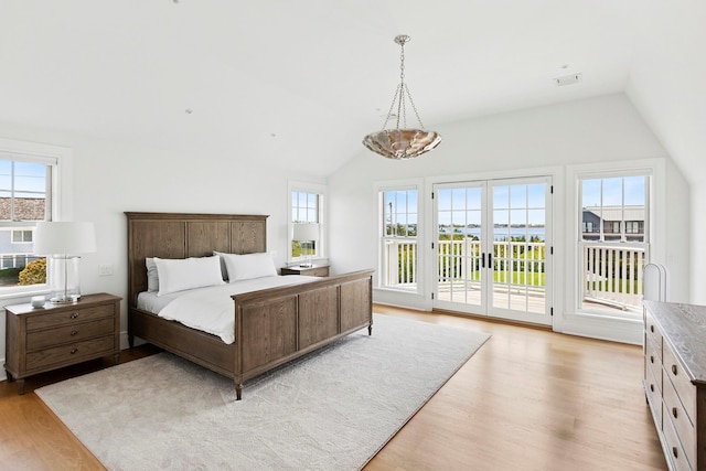1 Fiske Ave, Westhampton Beach, NY 11978 - bedroom with lofted ceiling, light wood-style floors, access to exterior, multiple windows, and french doors